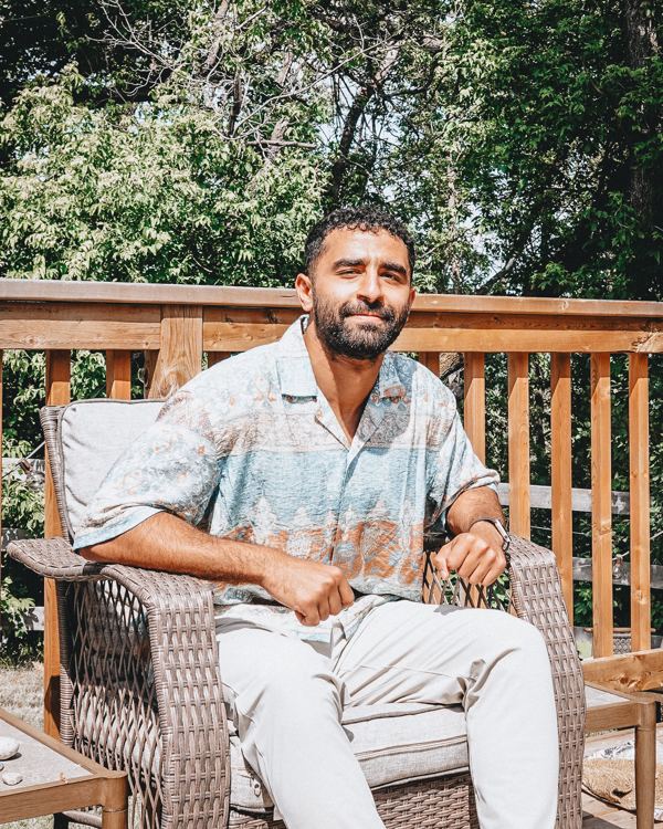 Abdel seated on a deck chair in the sun
